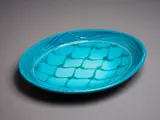 Merilyn Wiseman, Oval platter, white earthenware with a bright blue-green glaze, painted and carved abstract decoration