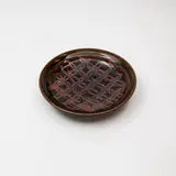 Graeme Storm, Stoneware dish, decorated with a tenmoku 'flower of life' wax resist design over dark olive glaze