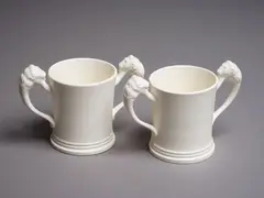 Two Coronation Loving cups by Crown Lynn Potteries, white slip-cast ceramic (not decorated), 1953, sold May 2024