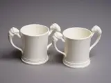 Two Coronation Loving cups by Crown Lynn Potteries, white slip-cast ceramic (not decorated), 1953, sold May 2024