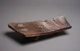 Large decorative three-footed platter by Chester Nealie, stoneware with brown salt glaze, shell impressions and stylised wave design, sold May 2024