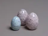 A collection of three eggs by Ola and Marie Hoglund, blown glass, sold May 2024