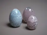 A collection of three eggs by Ola and Marie Hoglund, blown glass, sold May 2024