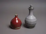 Nz Studio Pottery, Two stoneware bottles, comprising a Michael Block lidded bottle and a smaller red flambé bottle by an unidentified potter