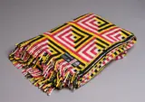 U.E.B. Textiles Ltd, Manatunga travel rug, with a tukutuku panel pattern in magenta, yellow, black, and white