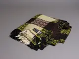 Mosgiel Woollens Ltd, Manatunga travel rug, decorated with a tukutuku panel pattern in olive green, brown, black and white (slight wear)