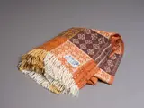 Onehunga Woollen Mills, Te Ariki travel rug, decorated with a tukutuku panel pattern in different shades of brown and white