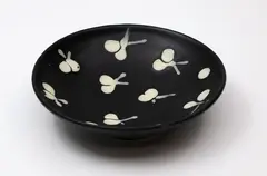 Small ceramic bowl by Potter Unknown, decorated with white stylized fruit design on a black background, with metal hanging fitting around the foot, sold Feb 2024