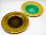 Jeannie van der Putten, Two large ceramic platters, the first glazed in yellow and aqua green, the second in olive green, tan and brown