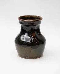 Stoneware vase by Barry Brickell, with shaped neck and shiny green and brown ash glaze, sold Feb 2024