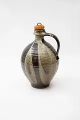 Mirek Smisek, Stoneware wine bottle, decorated with free-formed alternating panels of grey and tenmoku glazes, with original cane and cork stopper