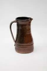 Stoneware jug by Len Castle, of elongated form, with tenmoku glaze, sold Feb 2024