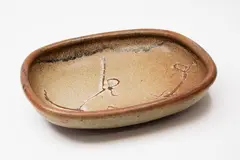Stoneware platter by Len Castle, with wax resist gestural decoration, sold Feb 2024
