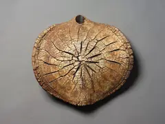 Large hanging form by Len Castle, stoneware with burnt umber washed textured surface, sold Feb 2024
