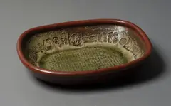 Large stoneware platter by Len Castle, ash and tenmoku glazed stoneware, the deep well walls impressed with various stamps, some attributed to Theo Schoon, imp, sold Feb 2024