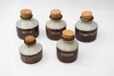 Andrew van der Putten and Len Castle, Five spice jars, stoneware with tenmoku and ash glaze, all with cork stoppers