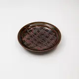 Graeme Storm, Stoneware dish, decorated with a tenmoku 'flower of life' wax resist design over dark olive glaze