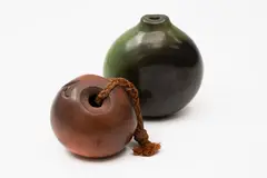 Robyn Stewart, Two small dung fired pots, comprising a small green bottle and an anchor stone form with rope handle