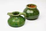 Green glazed squat jug by Jova Rancich & Joseph Radonich, with angular spout and handle; together with a green glazed vase, probably also by Jova Rancich, sold Feb 2024