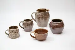 Hillside Pottery, Collection of five small salt glazed pots, comprising two jugs, a vase, a tea cup and a mug