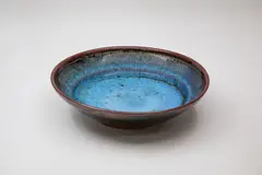 Stoneware bowl by Len Castle, shaped with a 'stepped' cavetto and decorated with jun and tenmoku glazes, sold Feb 2024
