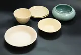 Group of six ceramics by Crown Lynn Potteries, including two Ambrico bowls, two Ambrico saucers, a matching ribbed bowl, and a blue glazed vase, sold Feb 2024