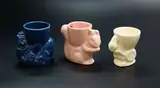Crown Lynn Potteries, Three egg cups, comprising a blue clown, a pink squirrel and a white rabbit
