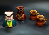 Two Toby jugs and two mugs by Crown Lynn Potteries, one Toby jug colourfully painted, the others with brown glazes, offered Feb 2024