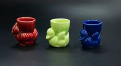 Three egg cups by Crown Lynn Potteries, comprising a green and a blue swimming ducks, and a red hen, sold Feb 2024