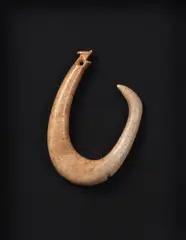 Matau, Carved one piece whalebone fish hook, late 18th to early 19th century, the top carved and with hole for attaching the muka cord, non-barbed with lashing groove