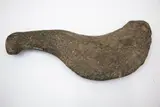 Patu Okewa, Rare Chatham Island curved stone okewa [hand club], bird shape, oval cross section. Worn oval knob on the top of the handle. Surface pitted and some flake scars, surfaces worn.