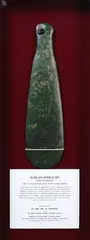 Mere Pounamu, [18th century], An exceptional pre-European pounamu mere of a translucent medium green colour with waves of white feathering, large well worn stone drilled hourglass hole.