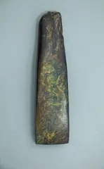 Toki - Adze, Large dark green pounamu toki, Straight blade with sharp corners, steep short bevel with marked chin. Straight vertical sides taper to damaged pole. Entire surface polished.