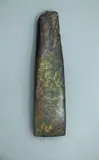 Toki - Adze, Large dark green pounamu toki, Straight blade with sharp corners, steep short bevel with marked chin. Straight vertical sides taper to damaged pole. Entire surface polished.