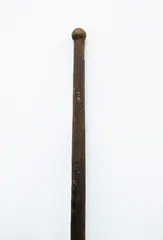 Kō, Digging Stick, long digging tool carved from medium brown wood, plain tapered shaft ending in flat rounded blade, light patina, blade chipped and short cracks, small single knob top of handle