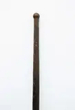 Kō, Digging Stick, long digging tool carved from medium brown wood, plain tapered shaft ending in flat rounded blade, light patina, blade chipped and short cracks, small single knob top of handle