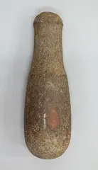 Patu Muka, Round based stone pounder, with pitting marks, shaft smooth, handle and top covered with hammer dressing, the round top is worn but remains of three concentric oval grooves on the top remain