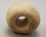 Mahi Kōhatu, Worked stone, a symmetrical cylindrical [?] Māori fishing stone, round hole drilled through the length of the stone, all edges and surfaces worn smooth