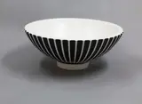 Large ribbed bowl by Norman Wilson for Wedgwood, with a moonstone glaze covered in a black slip (small chip), offered Oct 2023