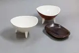 Two tripod bowls and a small dish by Norman Wilson for Wedgwood, one tripod in moonstone glaze, the other in red and white; the dish in 'hare's back' glaze, offered Oct 2023