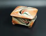 Merilyn Wiseman, Square lidded box, shino glazed earthenware with Mashiko-rock decoration in black, red and green on the exterior; the interior with delicate sage green glaze