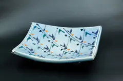 Large platter by Merilyn Wiseman, glazed slab platter on four lug feet, of square form with raised sides, decorated with abstract blue, green and orange m, sold Oct 2023