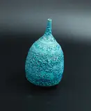 John Parker, Lava bud vase, azure blue glazed ceramic with textured volcanic crater motifs