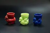 Three egg cups by Crown Lynn Potteries, comprising a green and a blue swimming ducks, and a red hen, offered Oct 2023