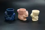 Crown Lynn Potteries, Three egg cups, comprising a blue clown, a pink squirrel and a white rabbit