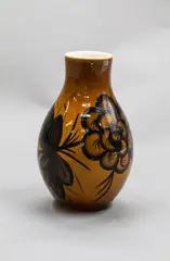 Hand-crafted vase by Daniel Steenstra for Crown Lynn, stylised painted black floral decoration on a brown lustre ground, sold Oct 2023
