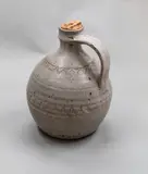 Nick Brandon, Early stoneware jug, with grey ash glaze, incised motif to the body and shoulder, original (worn) cork
