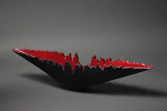 An Inverted Volcano by Len Castle, with red lava glaze interior and matte black exterior, sold Mar 2023