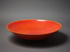 Graham Ambrose, Large earthenware charger, with rich orange sun glaze