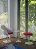Eero Saarinen, A ‘Tulip’ armchair, with classic red wool blend upholstery